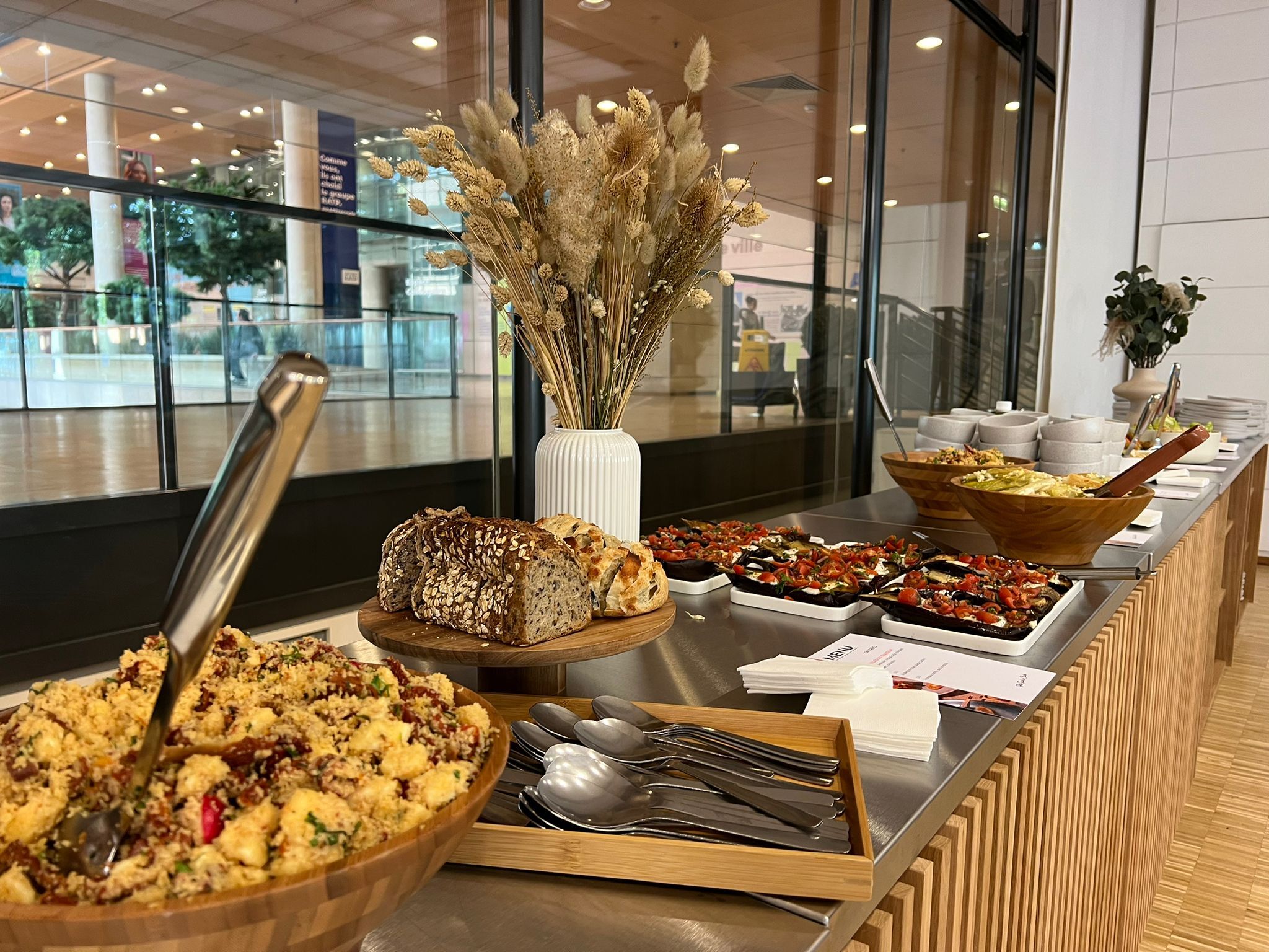 Buffet déjeunatoire pour événements professionnels avec salades de pâtes, aubergines, pains